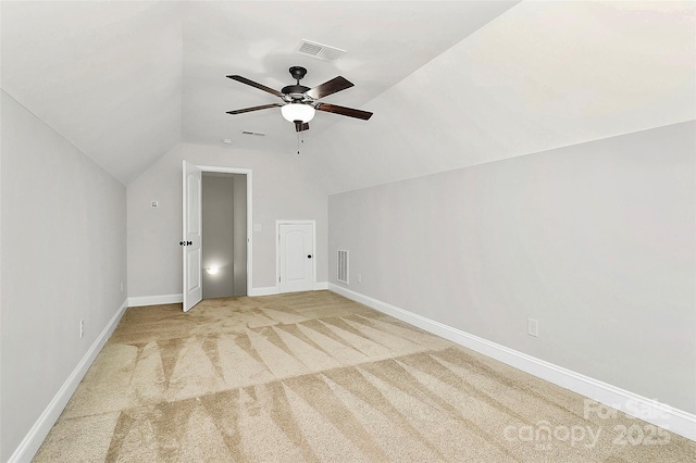 additional living space featuring vaulted ceiling, baseboards, visible vents, and light colored carpet