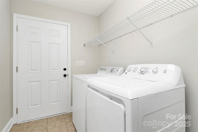 washroom featuring laundry area, light tile patterned floors, and washer and dryer