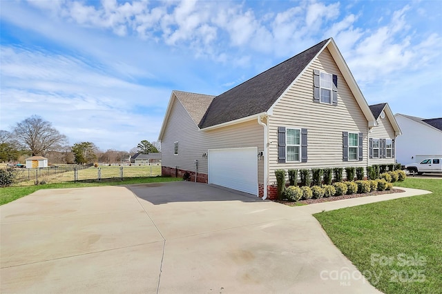 view of home's exterior with a garage, fence, a lawn, and concrete driveway