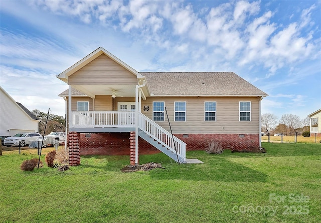 exterior space with a yard, fence, stairway, and a shingled roof