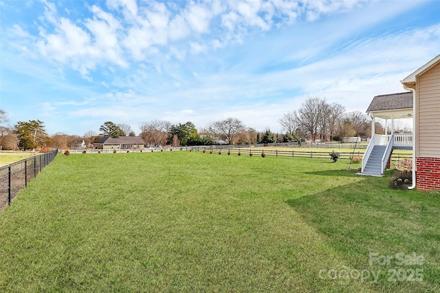 view of yard featuring a rural view and fence