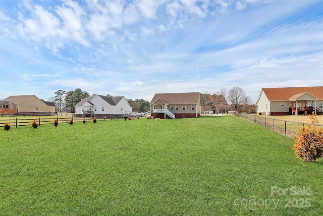 view of yard with fence and a rural view