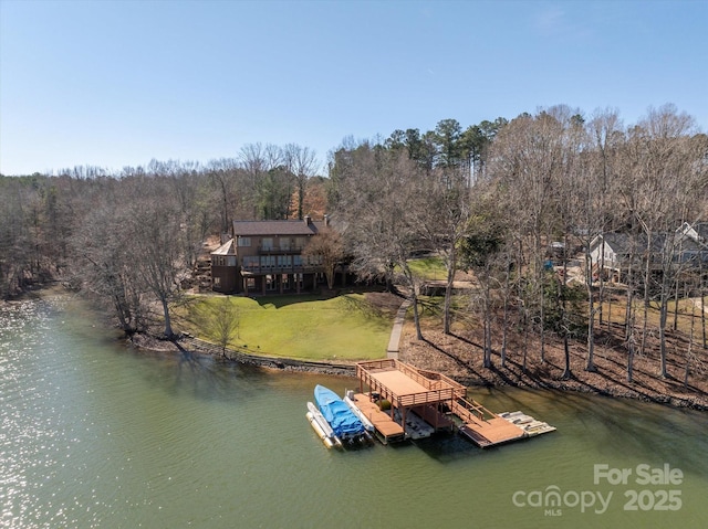 dock area featuring a lawn and a water view