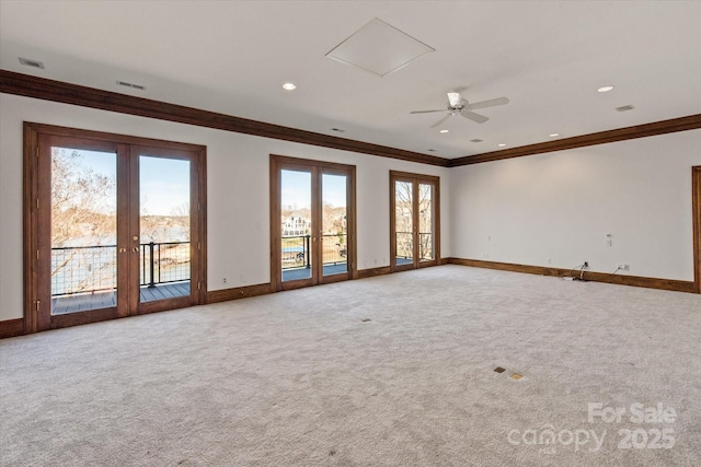 empty room featuring carpet floors, french doors, ornamental molding, and baseboards