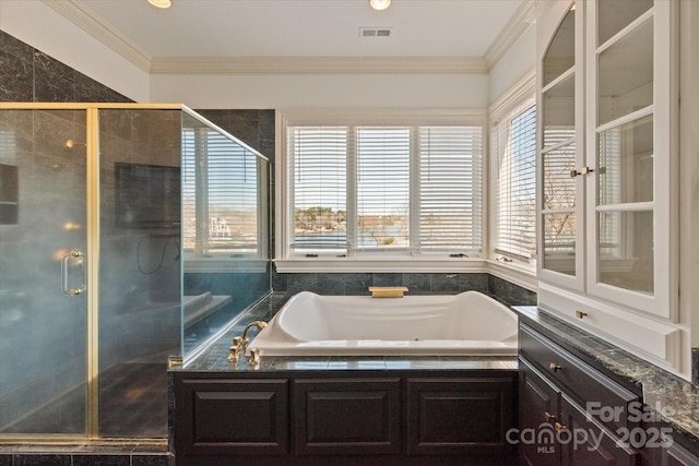 bathroom with a bath, a shower stall, visible vents, and crown molding