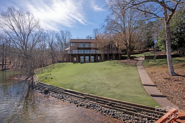 exterior space with a water view and a lawn