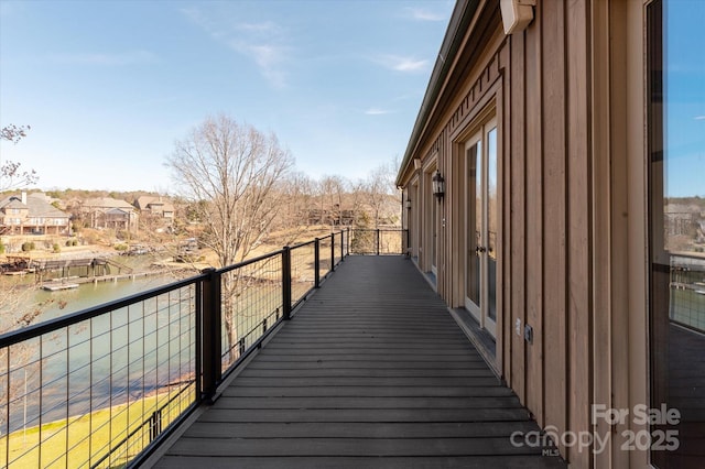 wooden deck with a water view and a residential view