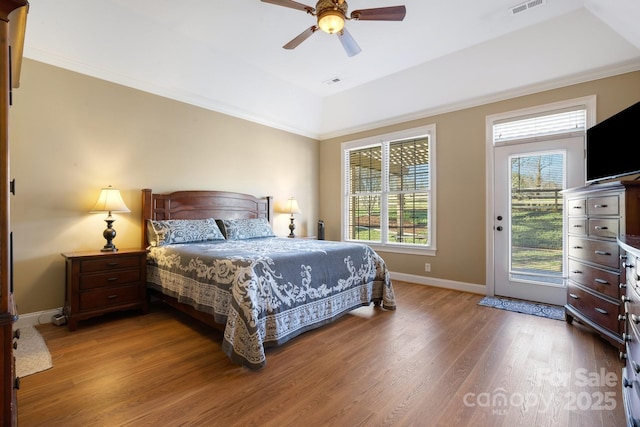 bedroom featuring hardwood / wood-style flooring, ceiling fan, ornamental molding, and access to exterior