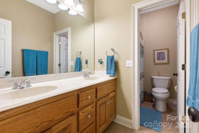 bathroom featuring vanity, toilet, and tile patterned flooring