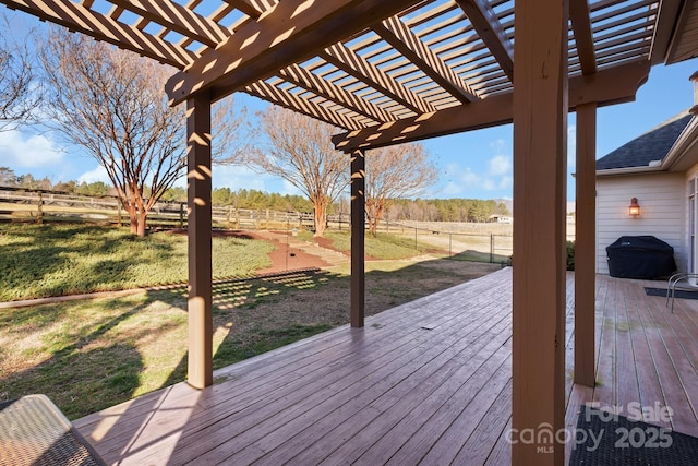 deck featuring a yard, a rural view, and a pergola