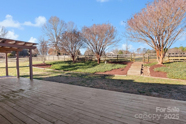 wooden deck featuring a pergola, a rural view, and a lawn