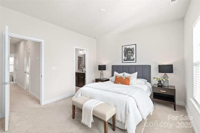 carpeted bedroom featuring ensuite bathroom