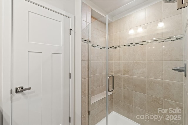 bathroom with a shower with door