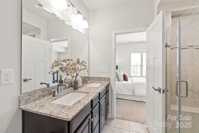 bathroom featuring tile patterned floors, an enclosed shower, and vanity