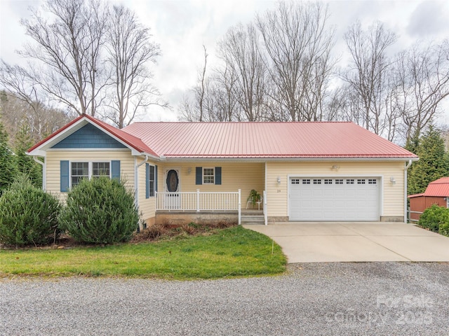 ranch-style home with a garage and covered porch