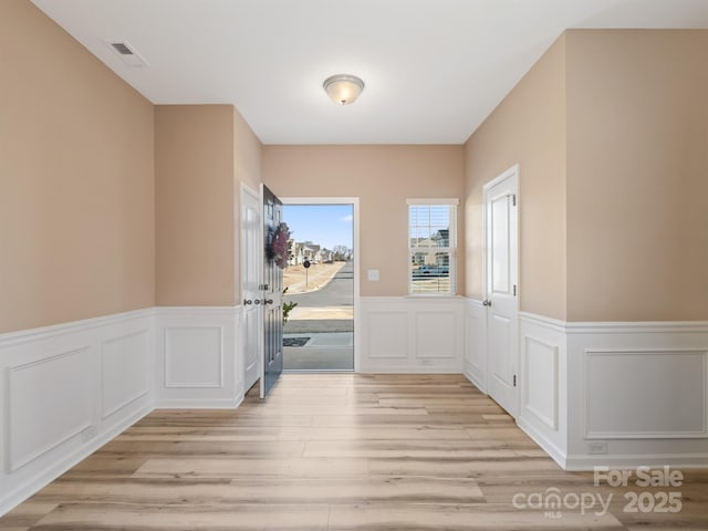 entryway with light hardwood / wood-style floors