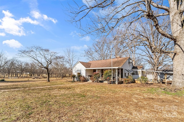 exterior space featuring a porch and a yard