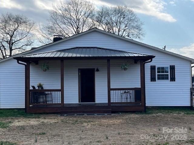 back of property with covered porch