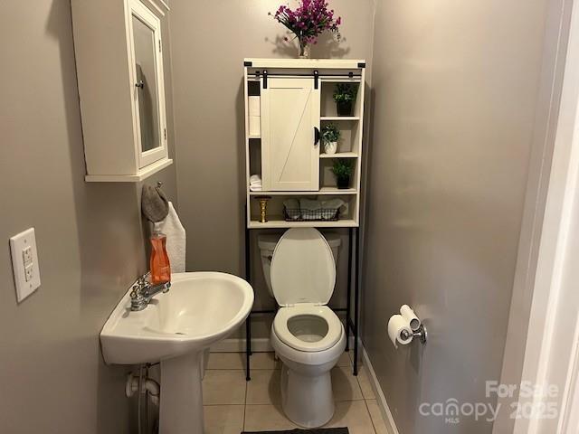 bathroom with tile patterned floors and toilet