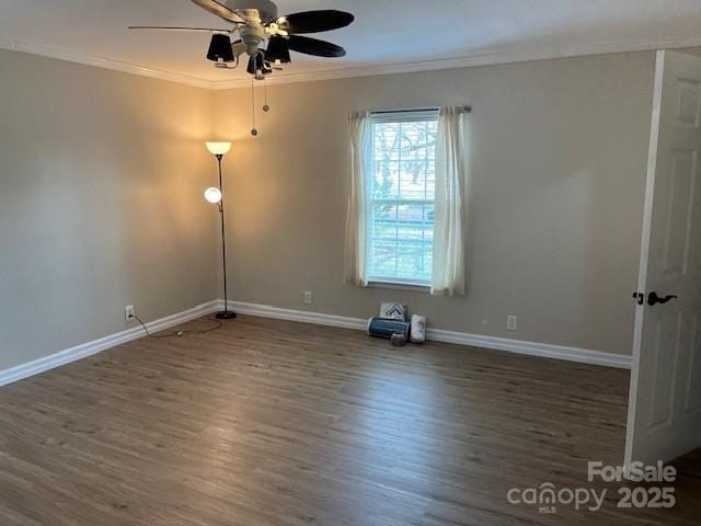 spare room with ceiling fan, ornamental molding, and dark hardwood / wood-style floors