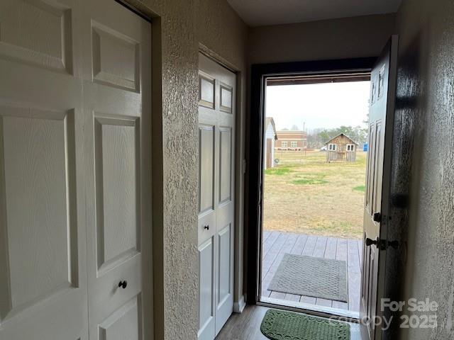 entryway with hardwood / wood-style flooring