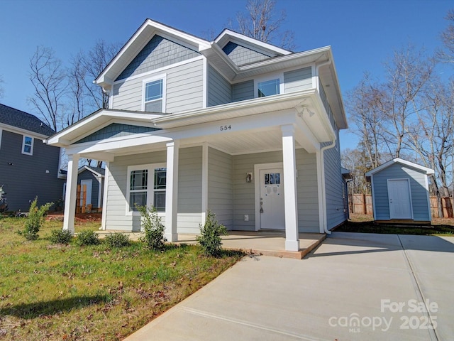 view of front facade with a storage shed and covered porch