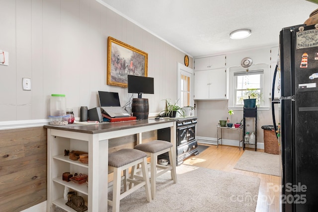 office space with crown molding, light hardwood / wood-style flooring, and a textured ceiling