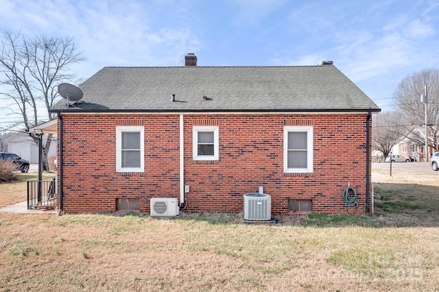 rear view of property featuring a yard, central AC unit, and ac unit