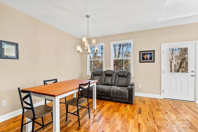 dining room with a chandelier and light hardwood / wood-style flooring