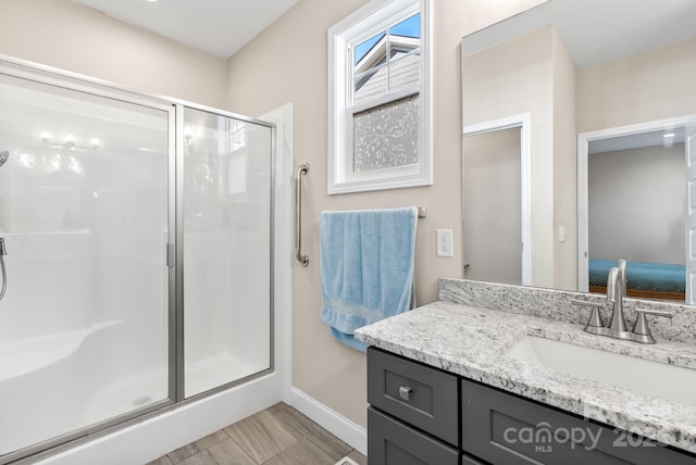bathroom featuring vanity and a shower with shower door