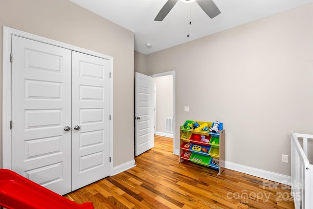 playroom featuring hardwood / wood-style flooring and ceiling fan