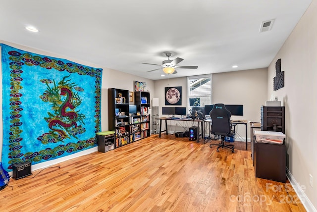 home office featuring hardwood / wood-style flooring and ceiling fan
