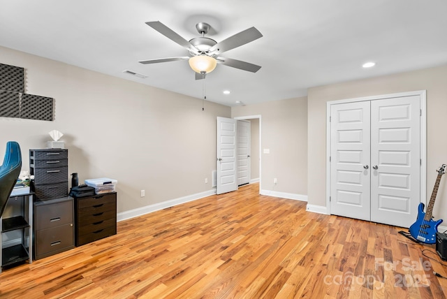 office space with ceiling fan and light hardwood / wood-style flooring