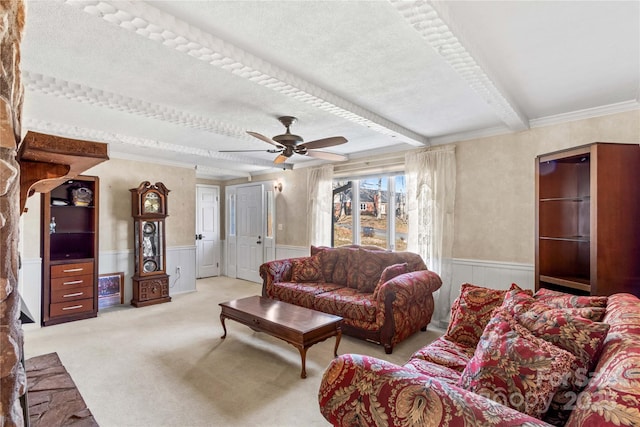 carpeted living room featuring beamed ceiling, ceiling fan, ornamental molding, and a textured ceiling