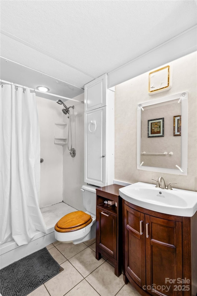 bathroom with tile patterned flooring, vanity, walk in shower, toilet, and a textured ceiling