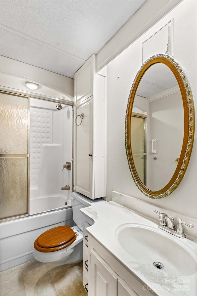 full bathroom with combined bath / shower with glass door, vanity, toilet, tile patterned floors, and a textured ceiling