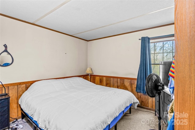 bedroom featuring ornamental molding, carpet flooring, and wood walls