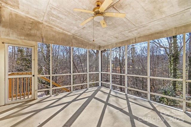 unfurnished sunroom featuring a wealth of natural light and ceiling fan