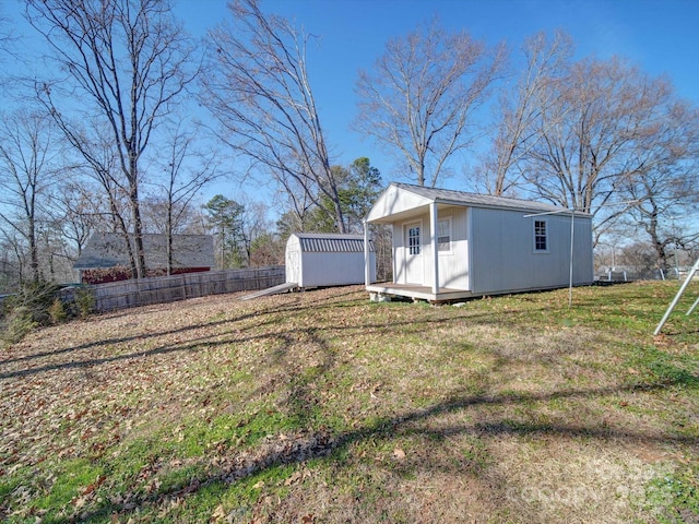 exterior space featuring a lawn and a storage unit