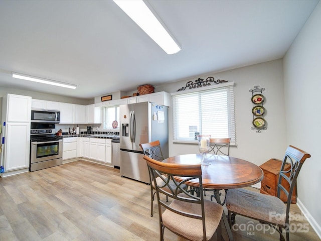 dining space featuring light hardwood / wood-style floors