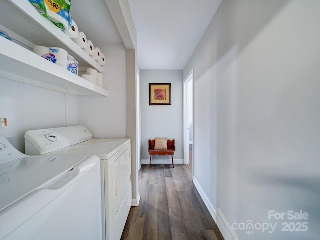 washroom with dark hardwood / wood-style flooring and washing machine and clothes dryer