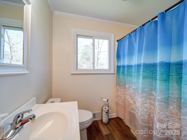 bathroom featuring sink, wood-type flooring, ornamental molding, and toilet