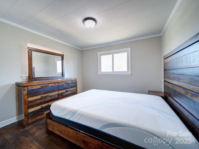 bedroom with ornamental molding and dark hardwood / wood-style floors