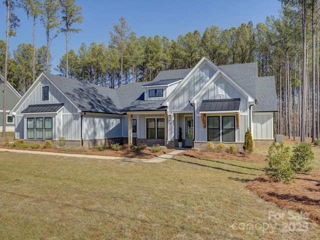 modern farmhouse style home with a front yard