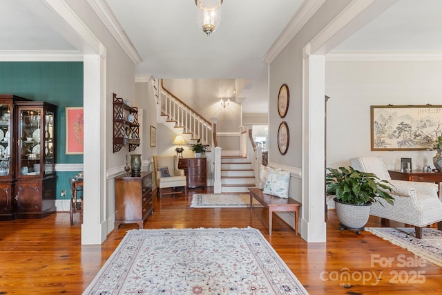 foyer featuring hardwood / wood-style floors and ornamental molding