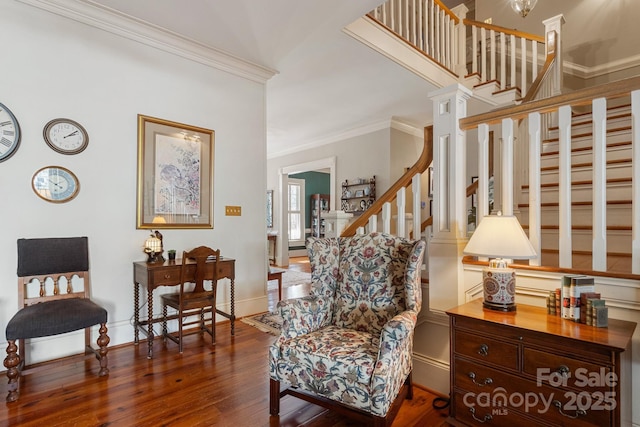 sitting room with ornamental molding and dark hardwood / wood-style floors