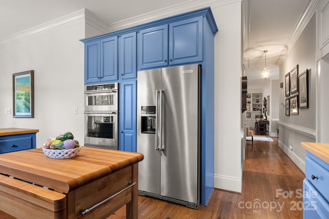 kitchen with blue cabinets, ornamental molding, and appliances with stainless steel finishes
