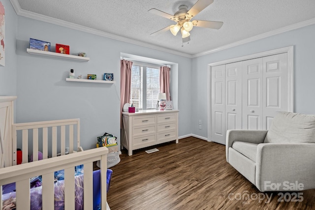 bedroom featuring dark wood-type flooring, crown molding, a textured ceiling, and a closet