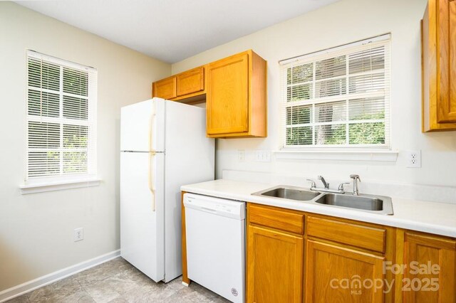 1748 Pergola Pl, Charlotte, NC 28213 - kitchen featuring a sink, light countertops, brown cabinets, and white appliances