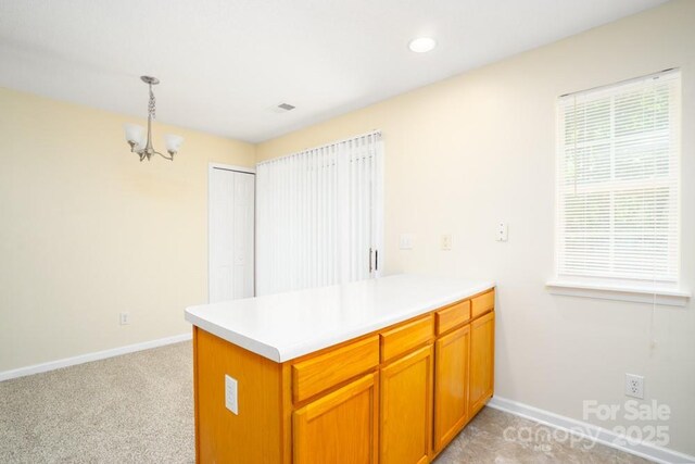 1748 Pergola Pl, Charlotte, NC 28213 - kitchen featuring brown cabinets, a peninsula, baseboards, and a chandelier